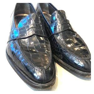 Men’s black crocodile loafers.
